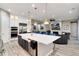 Gourmet kitchen with an island, bar seating, stainless-steel appliances, and open floor plan at 5072 Silver Hare Ln, Castle Rock, CO 80104