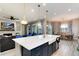 Spacious kitchen with an island, bar seating, and open to the living and dining areas at 5072 Silver Hare Ln, Castle Rock, CO 80104
