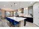 Bright kitchen with an island, bar seating, pendant lights, and stainless-steel appliances at 5072 Silver Hare Ln, Castle Rock, CO 80104