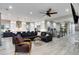 Spacious living area showcasing a fireplace, modern décor, and seamless flow to kitchen and staircase at 5072 Silver Hare Ln, Castle Rock, CO 80104
