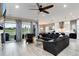 Open-concept living room with modern furnishings, a ceiling fan, and a seamless flow to the kitchen at 5072 Silver Hare Ln, Castle Rock, CO 80104