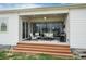 Covered patio with comfortable seating, a grill, and stairs to backyard at 5072 Silver Hare Ln, Castle Rock, CO 80104