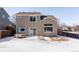 Backyard with patio and grassy area; view in winter at 11002 Glacier Park Cir, Parker, CO 80138