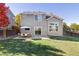 Spacious backyard with patio, landscaping, and wooden fence at 11002 Glacier Park Cir, Parker, CO 80138