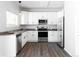 Modern kitchen with white cabinets, stainless steel appliances, and dark countertops at 11002 Glacier Park Cir, Parker, CO 80138