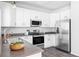 Modern kitchen featuring white cabinets, stainless steel appliances, and dark countertops at 11002 Glacier Park Cir, Parker, CO 80138