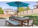 Relaxing patio area with wooden table, chairs, and umbrella at 11002 Glacier Park Cir, Parker, CO 80138