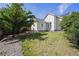 Backyard features a lush lawn, garden area, and the exterior of the house at 9908 Garfield Ct, Thornton, CO 80229