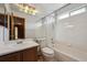 Bathroom with vanity, toilet, and shower over tub with a large mirror above the vanity at 9908 Garfield Ct, Thornton, CO 80229