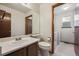 Well-lit bathroom with a light vanity and an adjacent laundry area at 9908 Garfield Ct, Thornton, CO 80229