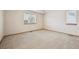 Bright and airy bedroom features neutral walls and plush carpeting at 9908 Garfield Ct, Thornton, CO 80229