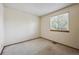 This empty bedroom has neutral paint, carpet, and a window letting in lots of light at 9908 Garfield Ct, Thornton, CO 80229