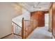 Hallway with wooden railings, stairs and a ceiling fan at 9908 Garfield Ct, Thornton, CO 80229