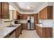 Well-equipped kitchen with stainless-steel appliances and wood cabinets at 9908 Garfield Ct, Thornton, CO 80229
