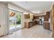 Open kitchen with stainless steel appliances, wooden cabinetry, and access to backyard at 9908 Garfield Ct, Thornton, CO 80229