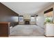 A vacant living room boasts a fireplace and many windows to let in natural light at 9908 Garfield Ct, Thornton, CO 80229