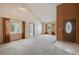 Bright living room with large windows, neutral carpet, and a vaulted ceiling at 9908 Garfield Ct, Thornton, CO 80229