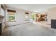 Open-concept living room flows into the kitchen, featuring updated flooring and natural light from large windows at 9908 Garfield Ct, Thornton, CO 80229
