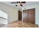 Bedroom features hardwood floors, large closet, and ceiling fan at 4866 S Dudley St # 2, Littleton, CO 80123