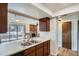 Kitchen sink overlooks the living room and stone fireplace at 4866 S Dudley St # 2, Littleton, CO 80123