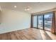 Living room featuring wood floors, neutral walls, and sliding glass doors to balcony at 4866 S Dudley St # 2, Littleton, CO 80123