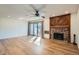 Bright living room featuring wood floors, stone fireplace, and sliding glass doors at 4866 S Dudley St # 2, Littleton, CO 80123