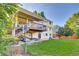 This large backyard has a deck, lawn, mature trees, and a small playhouse at 5622 E Weaver Cir, Centennial, CO 80111