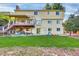 Spacious yard featuring a large lawn, covered deck, and sliding glass doors at 5622 E Weaver Cir, Centennial, CO 80111