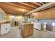 Spacious unfinished basement with wooden beams, laundry area, cabinetry, and concrete flooring at 5622 E Weaver Cir, Centennial, CO 80111