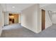 Finished basement features neutral carpet, white walls, and access to the laundry area at 5622 E Weaver Cir, Centennial, CO 80111