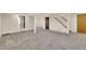 Finished basement with carpet, white pillars, and access to the utility room and stairway at 5622 E Weaver Cir, Centennial, CO 80111