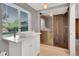 Modern bathroom features a glass shower enclosure, large window, and vessel sink vanity at 5622 E Weaver Cir, Centennial, CO 80111
