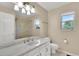Bathroom featuring a marble countertop, a shower with glass door, and a window at 5622 E Weaver Cir, Centennial, CO 80111