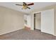 Comfortable bedroom with closet, fan, and view of the outdoor space at 5622 E Weaver Cir, Centennial, CO 80111