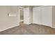 Bedroom with neutral paint, a closet, and a hallway entrance to the upper level of the home at 5622 E Weaver Cir, Centennial, CO 80111