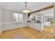 Dining area with hardwood floors, stylish lighting, and an open transition to the kitchen at 5622 E Weaver Cir, Centennial, CO 80111