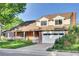 Charming two-story home with brick facade, covered porch, attached garage, and manicured lawn at 5622 E Weaver Cir, Centennial, CO 80111