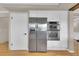Modern kitchen equipped with stainless steel refrigerator, wall oven, and white cabinetry at 5622 E Weaver Cir, Centennial, CO 80111