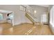 Bright living room featuring hardwood floors, staircase, stylish chandelier, and open layout at 5622 E Weaver Cir, Centennial, CO 80111