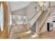 Bright living room with hardwood floors, a grand staircase, and stylish built-in shelving at 5622 E Weaver Cir, Centennial, CO 80111