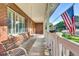 Inviting covered porch with a swing, offering a relaxing outdoor space with view of the yard at 5622 E Weaver Cir, Centennial, CO 80111