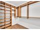 Walk-in closet with custom wood shelving and racks for ample storage at 5622 E Weaver Cir, Centennial, CO 80111
