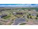 Aerial view of a property with a circular driveway, white fencing, and surrounding fields at 55610 E 40Th Ave, Strasburg, CO 80136