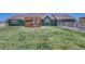 Large green backyard featuring a deck with pergola and a fenced-in yard at 55610 E 40Th Ave, Strasburg, CO 80136