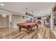 Finished basement featuring a pool table, workout area, and entertainment space with hardwood flooring and recessed lighting at 55610 E 40Th Ave, Strasburg, CO 80136