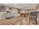 Basement area featuring a pool table, gym equipment, and bar-height seating at 55610 E 40Th Ave, Strasburg, CO 80136