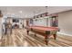 Spacious basement area showcasing a pool table, exercise equipment, home theater, and bar-height seating at 55610 E 40Th Ave, Strasburg, CO 80136