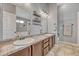 Bathroom featuring double sinks, a granite countertop, and decorative shelving for a modern touch at 55610 E 40Th Ave, Strasburg, CO 80136