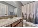 Cozy bathroom with updated vanity, granite countertops, and a shower-tub combination with stylish curtain at 55610 E 40Th Ave, Strasburg, CO 80136