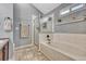 Bathroom featuring a shower with glass door, soaking tub, and a window for natural light at 55610 E 40Th Ave, Strasburg, CO 80136